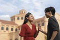 A young asian Christian couple holding hands in front of a church foreshadowing a future marriage Royalty Free Stock Photo