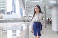 Young Asian confident business woman is going to the office or workplace which using a smartphone in big city with business Royalty Free Stock Photo