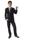 Young Asian Corporate Man pointing with thumb over