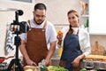 Asian couple blogger vlogger and online influencer recording video content on healthy food in the kitchen Royalty Free Stock Photo