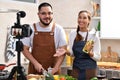 Asian couple blogger vlogger and online influencer recording video content on healthy food in the kitchen Royalty Free Stock Photo