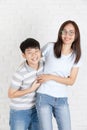 Young asian couple boy and girl on white wall background. Royalty Free Stock Photo