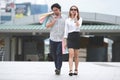 Young Asian couple carrying colorful shopping bags on city street Royalty Free Stock Photo