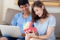 Young asian couple celebrate birthday together, asia man giving gift box present to woman for surprise at living room Royalty Free Stock Photo