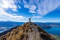 Young Asian couple celebrating success at Roys Peak Lake Wanaka New Zealand Royalty Free Stock Photo