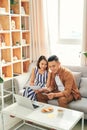 Young Asian couple checking bill and paying online with credit card Royalty Free Stock Photo