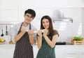 Young Asian couple cooking pizza in the white kitchen Royalty Free Stock Photo