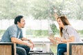 Young Asian couple or coworker talking at coffee shop or modern office Royalty Free Stock Photo