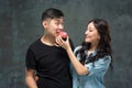 Young asian couple enjoy eating of sweet colorful donut Royalty Free Stock Photo