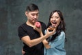 Young asian couple enjoy eating of sweet colorful donut Royalty Free Stock Photo