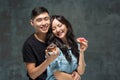 Young asian couple enjoy eating of sweet colorful donut Royalty Free Stock Photo