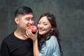 Young asian couple enjoy eating of sweet colorful donut Royalty Free Stock Photo