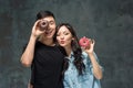 Young asian couple enjoy eating of sweet colorful donut Royalty Free Stock Photo