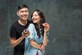 Young asian couple enjoy eating of sweet colorful donut Royalty Free Stock Photo