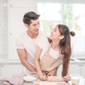 Young Asian couple happy hugging loving couple bakers helping to make dinner. Royalty Free Stock Photo