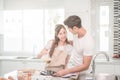 Young Asian couple happy loving couple bakers helping to make dinner. Royalty Free Stock Photo