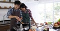 Young Asian couple are happy to cook together, two families are helping each other prepare to cook Royalty Free Stock Photo