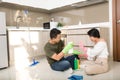 Young Asian couple having fun while doing spring cleaning together Royalty Free Stock Photo