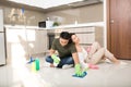 Young Asian couple having fun while doing spring cleaning together