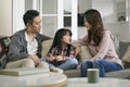 young asian couple having a pleasant conversation with daughter at home Royalty Free Stock Photo