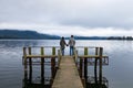 Young Asian couple holding hands on the bridge Lake Te Anau New Zealand