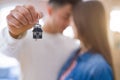 Young asian couple holding keys of new house, smiling happy and excited moving to a new apartment Royalty Free Stock Photo