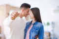 Young asian couple holding keys of new house, smiling happy and excited moving to a new apartment Royalty Free Stock Photo