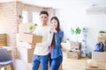 Young asian couple holding keys of new house, smiling happy and excited moving to a new apartment Royalty Free Stock Photo