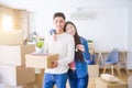 Young asian couple holding keys of new house, smiling happy and excited moving to a new apartment Royalty Free Stock Photo