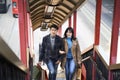 Young asian couple asending a footbridge Royalty Free Stock Photo