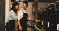 Young asian couple husband and wife in kitchen having romantic and fun moment during coronavirus pandemic lock down baking bakery Royalty Free Stock Photo