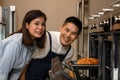 Young asian couple husband and wife in kitchen having romantic and fun moment during coronavirus pandemic lock down baking bakery Royalty Free Stock Photo