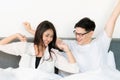 Young asian couple love man and woman woke up in morning on the bed and happy moment Royalty Free Stock Photo