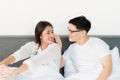 Young asian couple love man and woman woke up in morning on the bed and happy moment Royalty Free Stock Photo