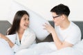 Young asian couple love man and woman woke up in morning has pillow fight on the bed and happy moment Royalty Free Stock Photo