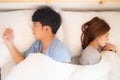 Young asian couple lying separate and failure on bed at home, asia family having problem conflict and divorce Royalty Free Stock Photo