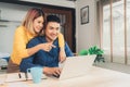 Young asian couple managing finances, reviewing their bank accounts using laptop computer and calculator at modern home. Woman and Royalty Free Stock Photo