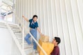 Young asian couple moving and carrying boxes upstairs in new house, celebrating moving to new home concept Royalty Free Stock Photo