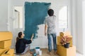 Young asian couple painting interior wall with paint roller in n Royalty Free Stock Photo