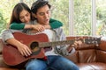 Young Asian Couple Plays Guitar and Sing Song Royalty Free Stock Photo