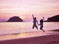 Young asian couple rejoicing at sunrise