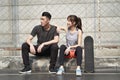 Young asian couple resting and relaxing after outdoor exercise Royalty Free Stock Photo