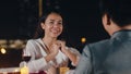 Young asian couple romantic dinner in rooftop restaurant at night city with happy moment celebrate anniversary relationship. Love Royalty Free Stock Photo