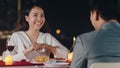 Young asian couple romantic dinner in rooftop restaurant at night city with happy moment celebrate anniversary relationship. Love Royalty Free Stock Photo