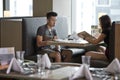 Young Asian couple seating at a restaurant