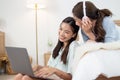 Young asian couple smiling happy using laptop at bedroom. Female friends are happily using credit cards for online shopping. Royalty Free Stock Photo