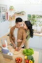 Young Asian couple. Standing cooking in the kitchen Royalty Free Stock Photo