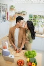 Young Asian couple. Standing cooking in the kitchen Royalty Free Stock Photo