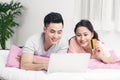 Young asian couple surfing on internet and shopping with laptop Royalty Free Stock Photo