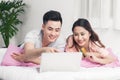 Young asian couple surfing on internet and shopping with laptop Royalty Free Stock Photo